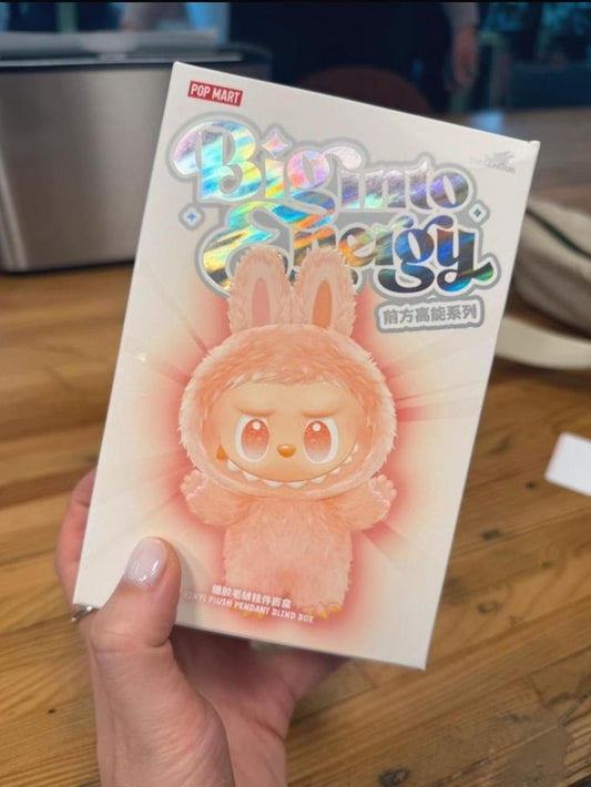 Card with a cute character design held by a hand on a wooden surface